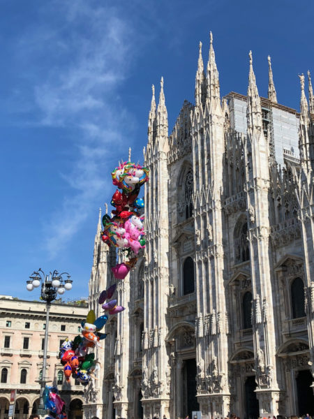 string of bright balloons in front of the Duomo, Milan.