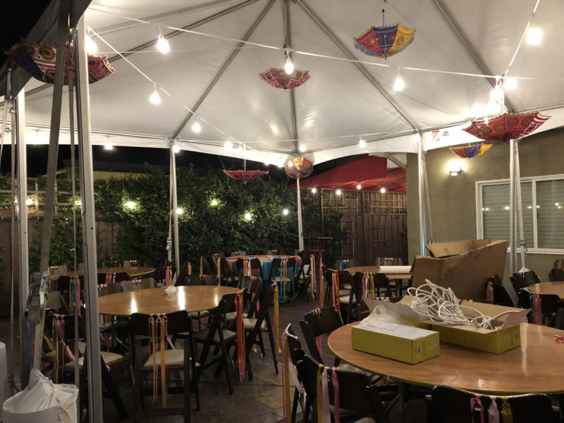 tent decorated with lights and umbrellas