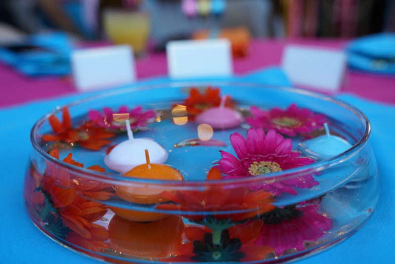 glass bowl with water and floating candles and flowers
