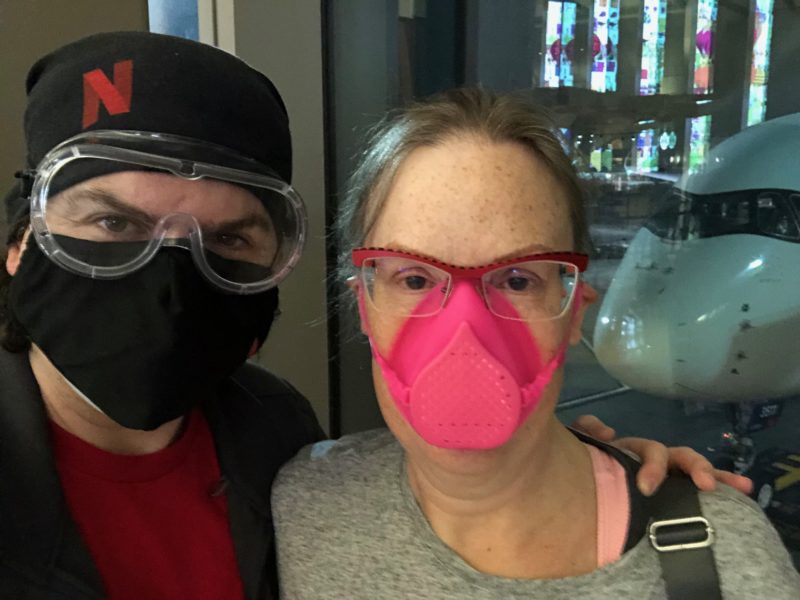 Brendan Gregg wearing a black mask and black headscarf with the Netflix N in red (he looks like a ninja), Deirdré Straughan in a bright pink silicon face mask, looking like Miss Piggya