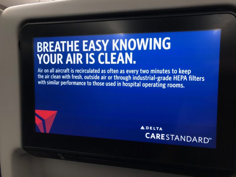 sign on Delta's in-flight entertainment system saying "Breathe easy knowing your air is clean"