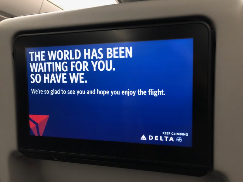 sign on Delta's in-flight entertainment system saying "The world has been waiting for you. So have we."