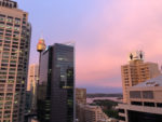 pink sunset clouds through tall buildings in Sydney CBD