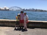 Mitchell, Brendan, and Deirdré in front of a view of the Sydney Harbour Bridge