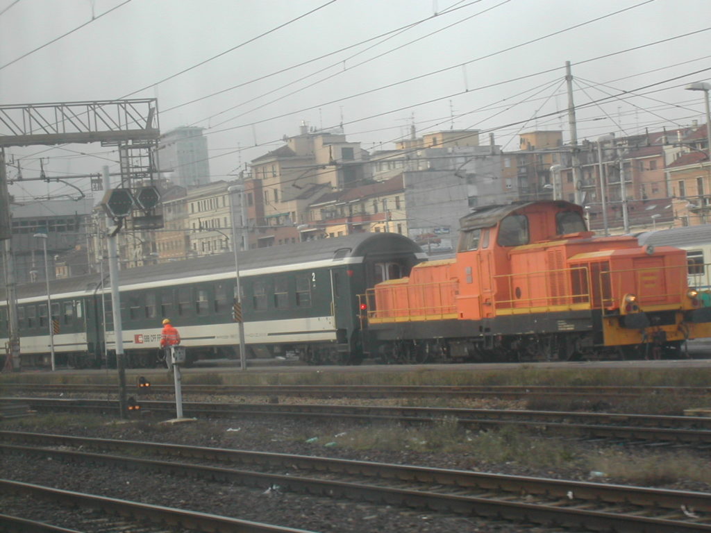 train parked outside Milan Central Station on a gloomy day