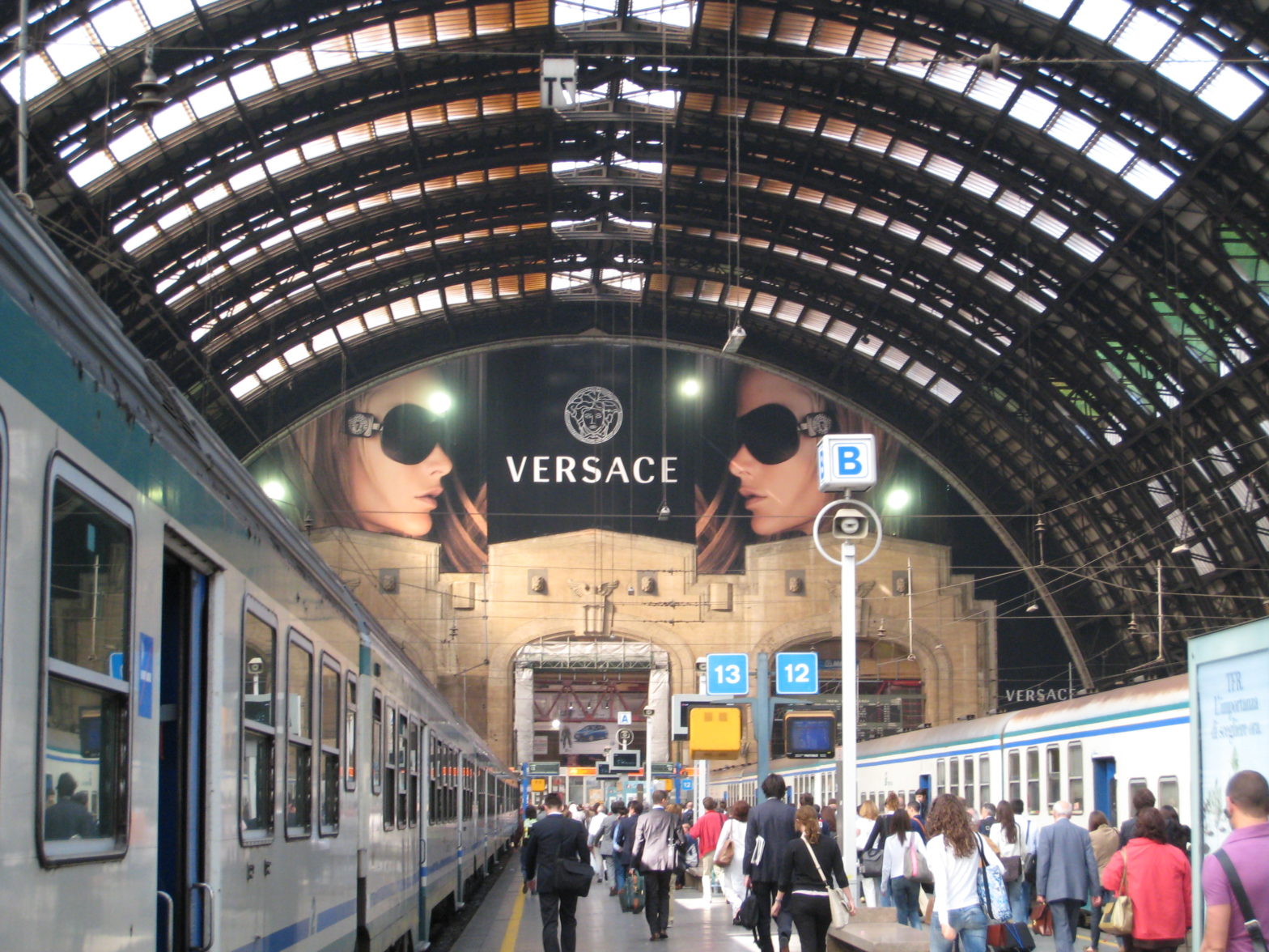 Milan Central Station, view from platform to main station with large Versace ad near the ceiling