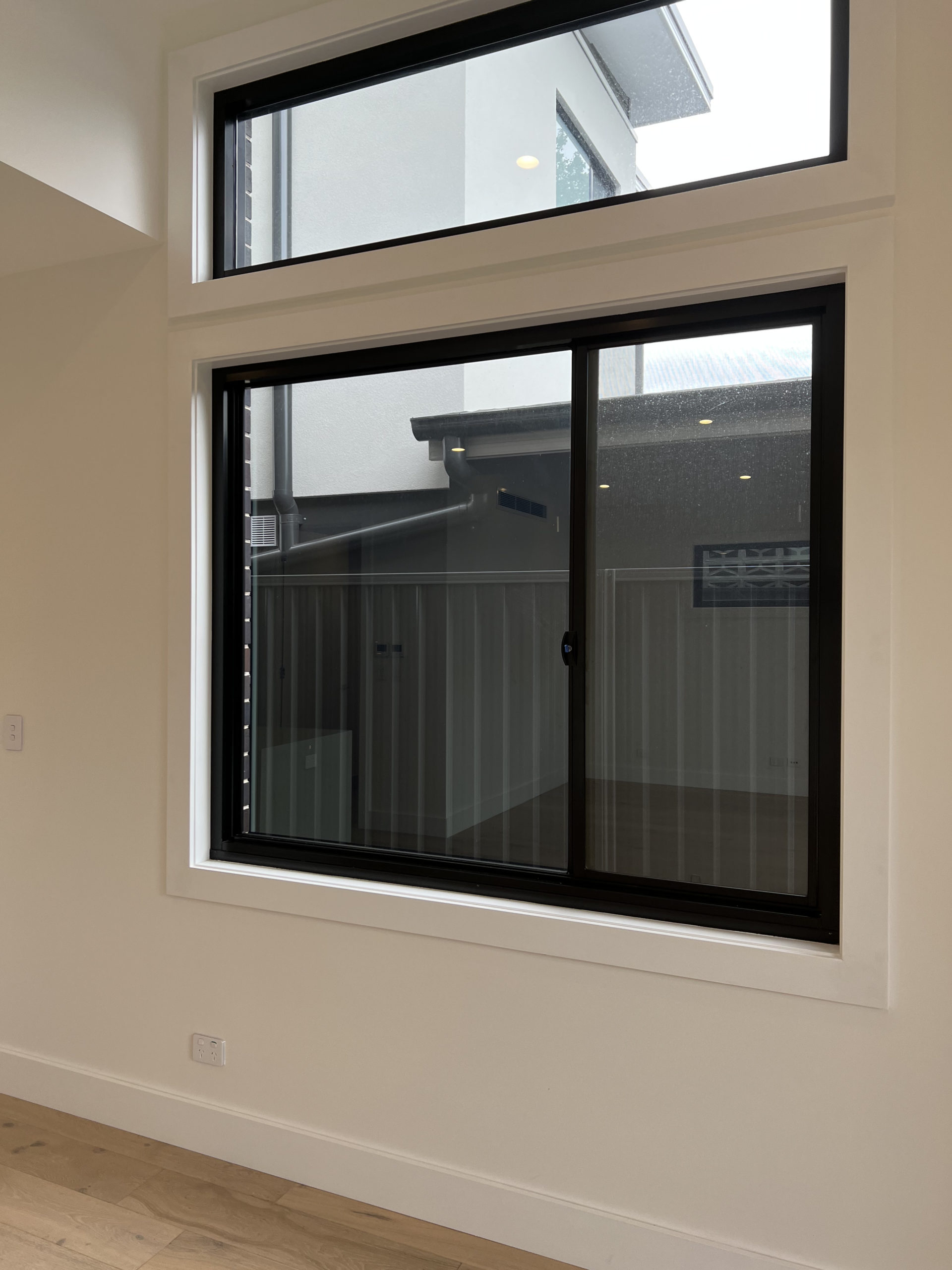 windows in a duplex with a view of the neighboring fence