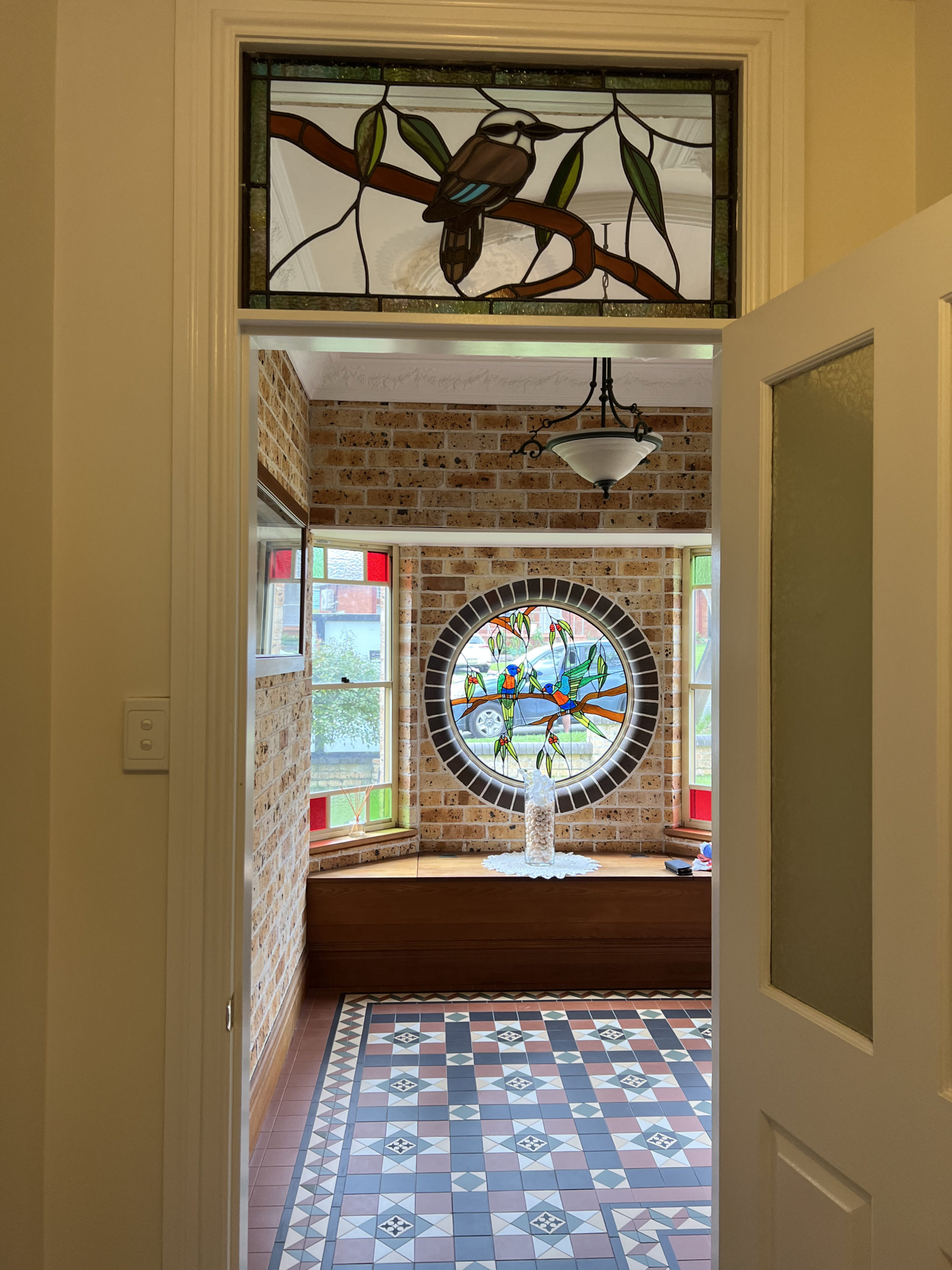 view of the round lorikeet window and over-door kookaburra window, looking out from entrance hall