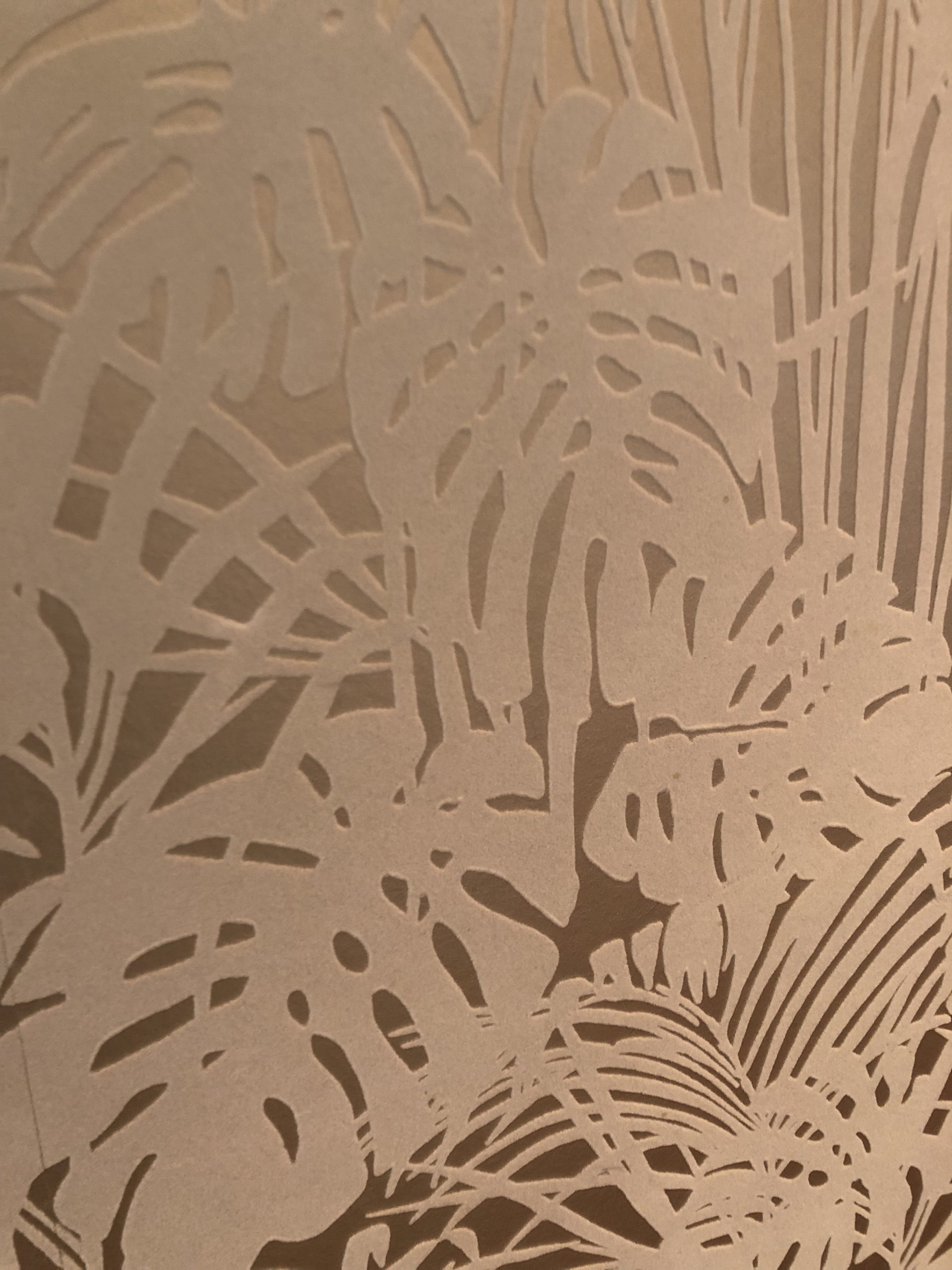 wallpaper: monstera leaves in white velvet flocking on a shiny background
