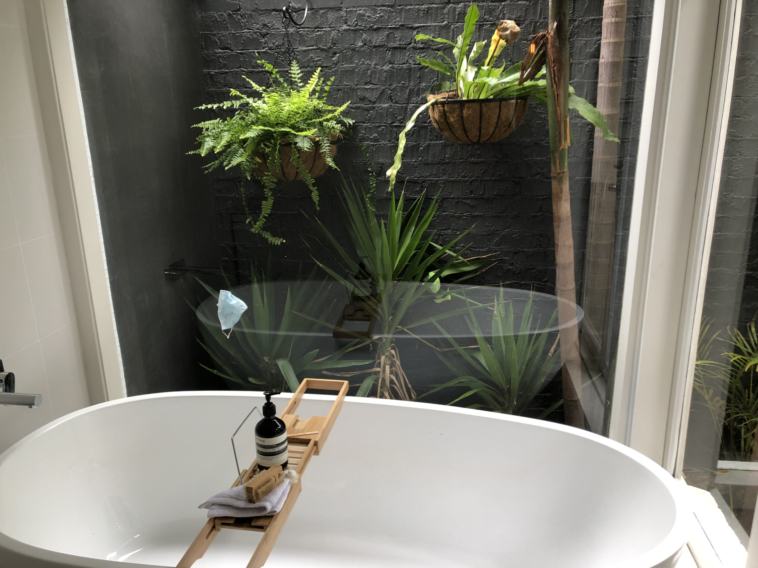 bathtub looking onto a private garden