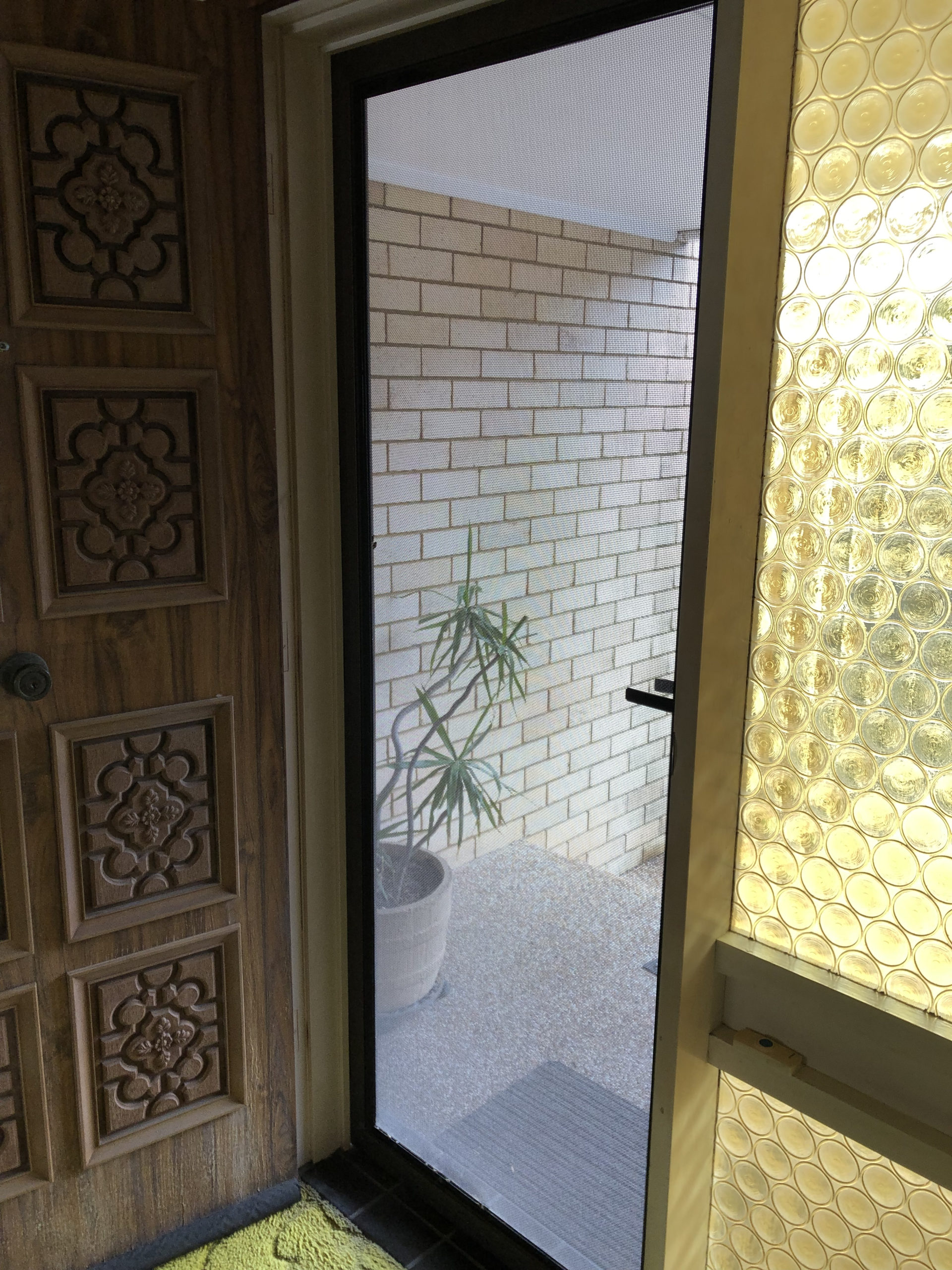 door with molded patterns, side window with yellow plastic bottle end style glass