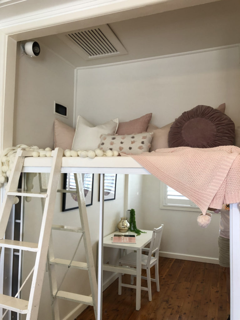 loft bed above a half-height built in closet