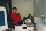 Deirdré at her desk at Incat Systems' Campbell CA office - I'm in the background wearing a red sweatshirt, surrounded by beige-colored electronics (CRT monitor, printer, office phone...)
