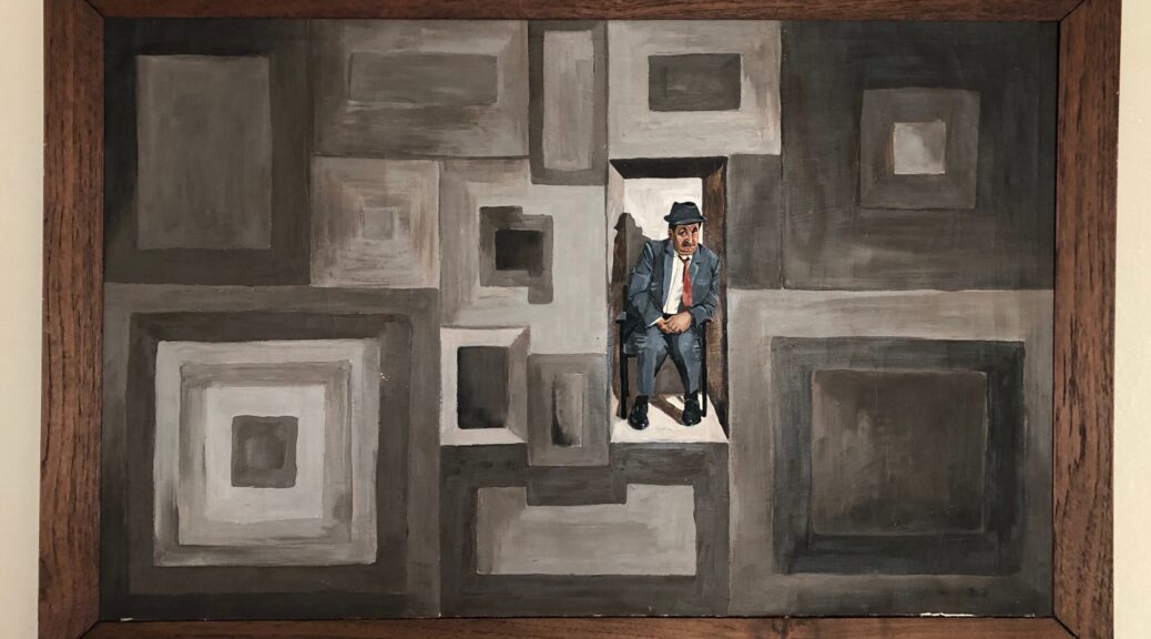 a rectangular painting with abstract rectangles in shades of dull brown. One rectangle is a recessed box in which a man sits in a black metal chair. He wears a blue suit and white shirt with a red tie askew, and a black hat with a narrow brim curled up in front. His hands are clasped in his lap and he looks diffidently at the viewer